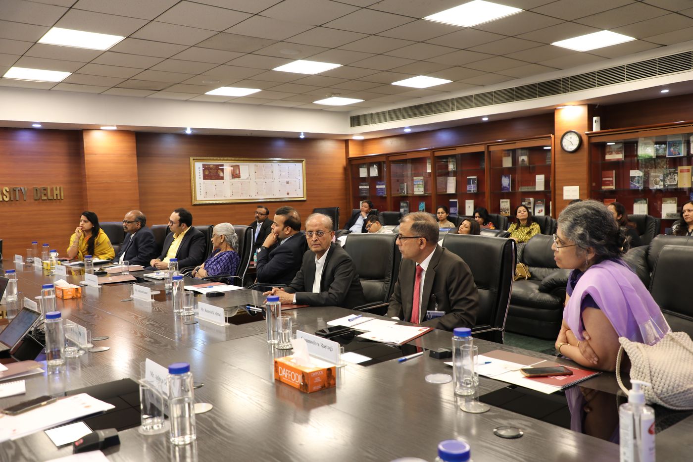 A roundtable at the University: participants seated round a long conference table.